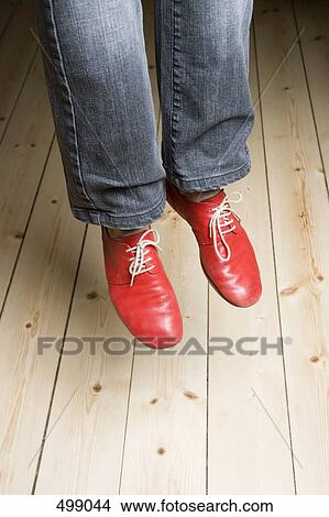 Picture - Low section of a woman in mid-air. Fotosearch