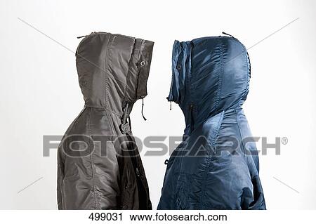 Two men wearing hooded parkas standing face to face View Large Photo Image Stock Image - Two men wearing hooded parkas standing face to face. Fotosearch