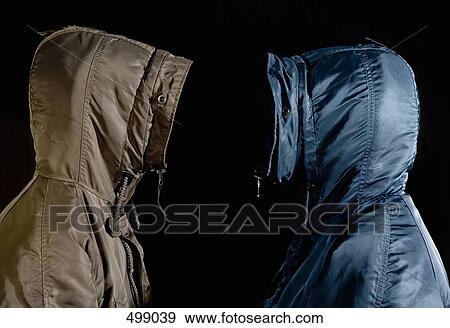Stock Photo - Two men wearing hooded parkas standing face to face. Fotosearch