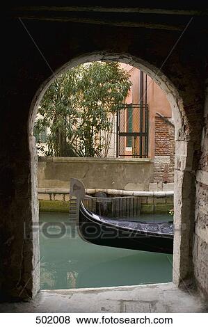 Stock Photo - An archway on to a canal in Venice. Fotosearch