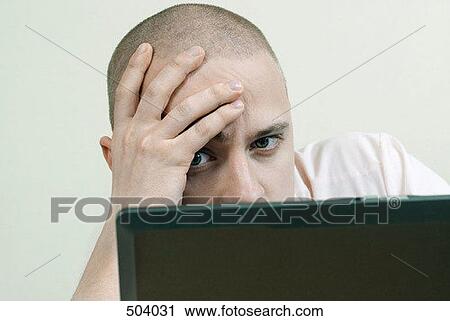 A man staring at a laptop View Large Photo Image Stock Image - A man staring at a laptop. Fotosearch