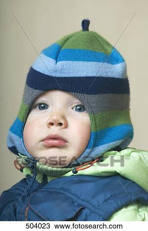 Stock Image - A portrait of a baby boy wearing winter clothing. Fotosearch