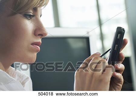 A woman using a mobile phone with a digitized pen View Large Photo Image Stock Photo - A woman using a mobile phone with a digitized pen. Fotosearch