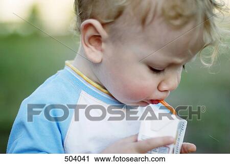 A young boy holding a juice box View Large Photo Image Stock Image - A young boy holding a juice box. Fotosearch