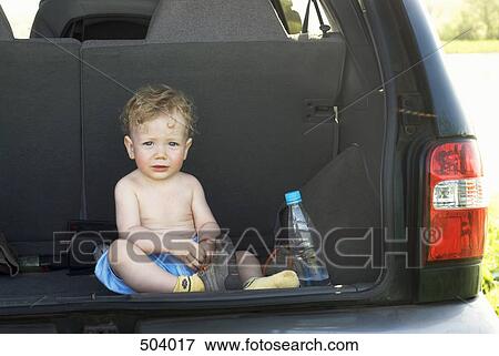 A young boy sitting in the back of an SUV View Large Photo Image Stock Photo - A young boy sitting in the back of an SUV. Fotosearch