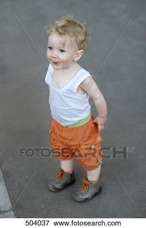 A young boy standing in anticipation View Large Photo Image Stock Photo - A young boy standing in anticipation. Fotosearch