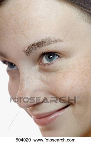 Stock Image - A young woman looking up and smiling. Fotosearch