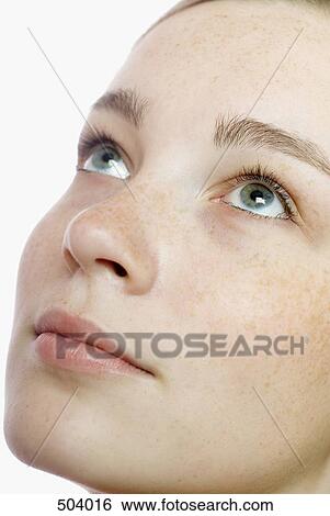 Stock Photograph - A young woman looking up. Fotosearch
