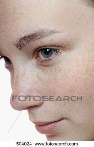 Close-up of a young woman looking away View Large Photo Image Picture - Close-up of a young woman looking away. Fotosearch
