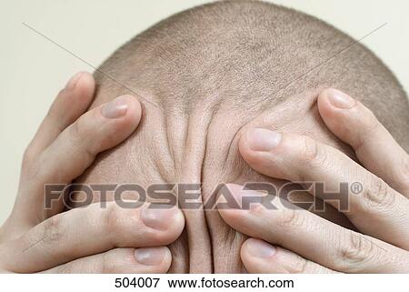 Stock Photo - Detail of a man rubbing his head. Fotosearch