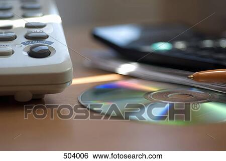 Detail of a telephone, CD, pen and calculator on a desk View Large Photo Image Stock Photograph - Detail of a telephone, CD, pen and calculator on a desk. Fotosearch