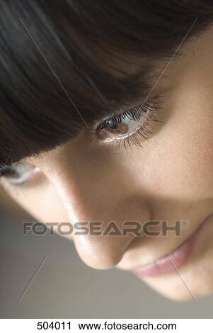 Stock Image - Detail of a woman day dreaming. Fotosearch