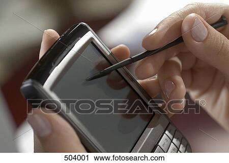 Detail of a woman using a mobile phone with a digitized pen View Large Photo Image Stock Image - Detail of a woman using a mobile phone with a digitized pen. Fotosearch