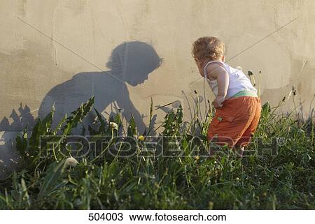 Rear view of a young boy picking flowers View Large Photo Image Stock Image - Rear view of a young boy picking flowers. Fotosearch