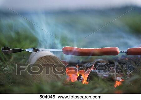 Sausages grilling over a fire View Large Photo Image Stock Photography - Sausages grilling over a fire. Fotosearch