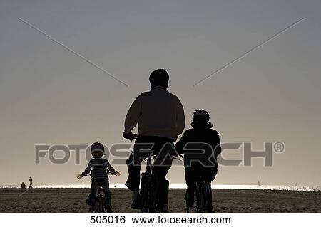 A family cycling at the beach View Large Photo Image Stock Photograph - A family cycling at the beach. Fotosearch
