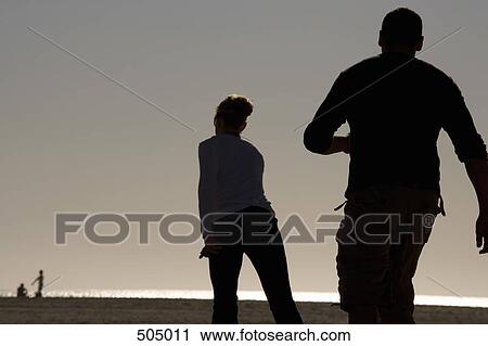 Stock Image - Two people rollerblading. Fotosearch
