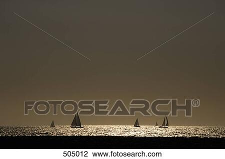 Stock Image - Yachts sailing in the sea. Fotosearch