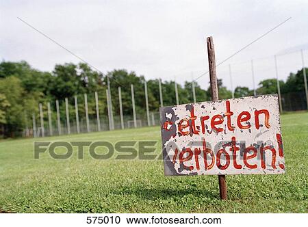 Warning sign in a field grass View Large Photo Image Stock Image - Warning sign in a field grass. Fotosearch