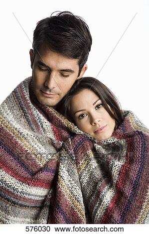 A couple wrapped in a blanket View Large Photo Image Stock Image - A couple wrapped in a blanket. Fotosearch