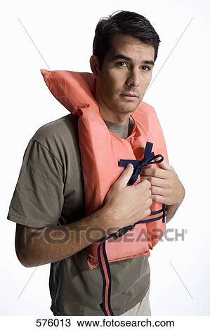 A man wearing a life jacket View Large Photo Image Stock Image - A man wearing a life jacket. Fotosearch