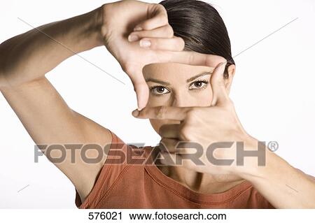 A woman looking through her fingers, making a viewfinder View Large Photo Image Stock Image - A woman looking through her fingers, making a viewfinder. Fotosearch