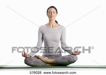 A woman sitting in the lotus position View Large Photo Image Stock Photo - A woman sitting in the lotus position. Fotosearch