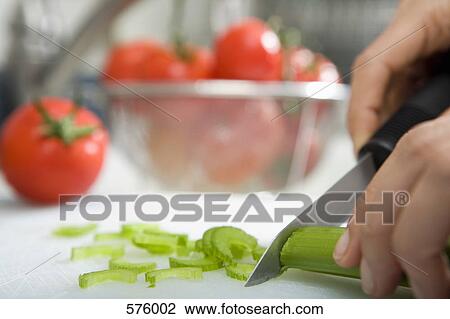Close up of hand chopping celery View Large Photo Image Stock Image - Close up of hand chopping celery. Fotosearch