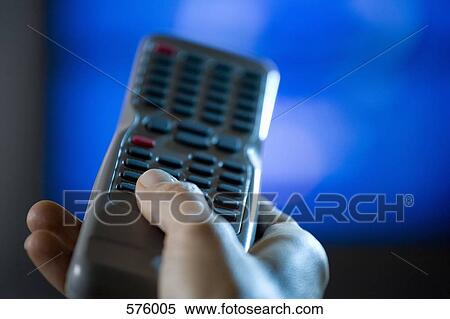 Close up of hand holding remote control View Large Photo Image Stock Photography - Close up of hand holding remote control. Fotosearch