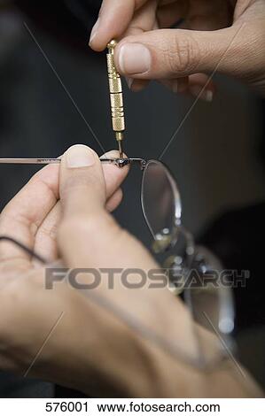 Close up of hands repairing glasses View Large Photo Image Stock Image - Close up of hands repairing glasses. Fotosearch
