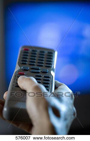Stock Photo - Hand holding a remote control. Fotosearch