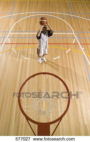 A young man about to shoot a basket View Large Photo Image Stock Photo - A young man about to shoot a basket. Fotosearch