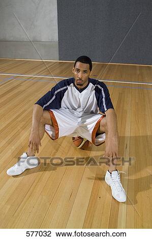 A young man looking serious sitting on a basketball View Large Photo Image Stock Image - A young man looking serious sitting on a basketball. Fotosearch