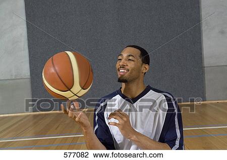 A young man spinning a basketball on his finger View Large Photo Image Stock Image - A young man spinning a basketball on his finger. Fotosearch