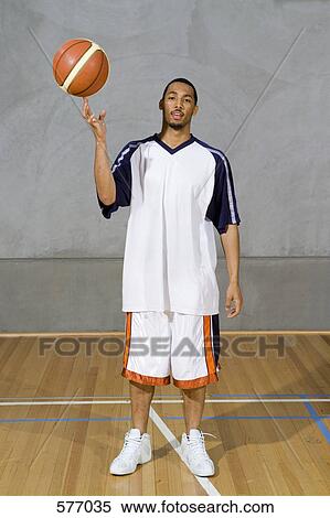 A young man spinning a basketball on his finger View Large Photo Image Stock Photography - A young man spinning a basketball on his finger. Fotosearch