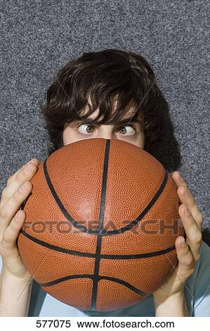 Stock Photography - Man with a basketball covering most of his face. Fotosearch