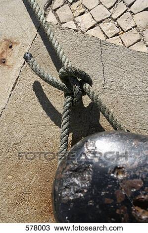 Stock Image - Nautical knot tied to a bollard. Fotosearch