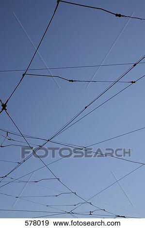 Stock Photo - Power cables with blue sky background. Fotosearch