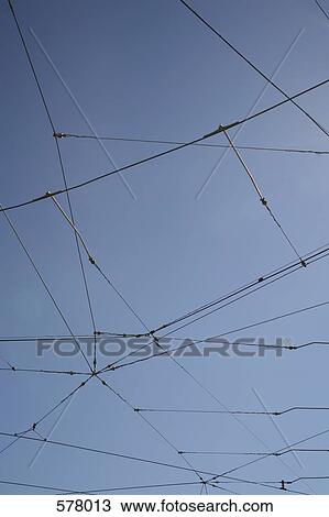 Power lines against a blue sky View Large Photo Image Stock Image - Power lines against a blue sky. Fotosearch