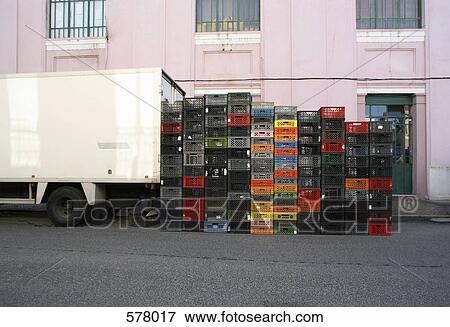 Stack of crates next to a delivery truck View Large Photo Image Stock Photo - Stack of crates next to a delivery truck. Fotosearch