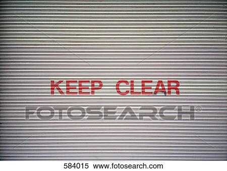 Keep Clear sign on a garage door View Large Photo Image Stock Photography - Keep Clear sign on a garage door. Fotosearch