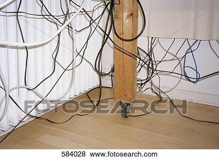 Messy cables hanging underneath a table View Large Photo Image Stock Photo - Messy cables hanging underneath a table. Fotosearch