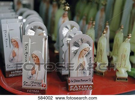 Stock Image - Virgin Mary statuettes in a shop. Fotosearch