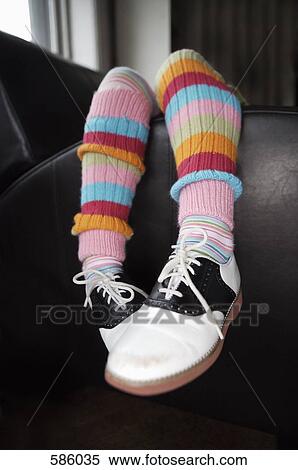 A child's legs draped over an arm rest View Large Photo Image Stock Photography - A child's legs draped over an arm rest. Fotosearch