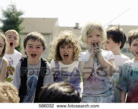 A medium group of children in paint splattered clothes yelling at the camera View Large Photo Image Stock Image - A medium group of children in paint splattered clothes yelling at the camera. Fotosearch