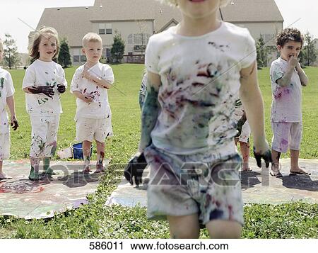 A medium group of children with paint splattered clothes View Large Photo Image Stock Image - A medium group of children with paint splattered clothes. Fotosearch