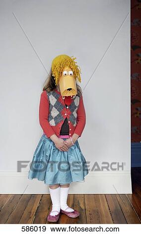 A portrait of young girl with a mask obscuring her face View Large Photo Image Stock Photo - A portrait of young girl with a mask obscuring her face. Fotosearch