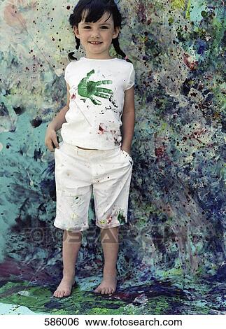 A young girl standing on a paint splattered backdrop with paint splattered white clothes on View Large Photo Image Stock Photograph - A young girl standing on a paint splattered backdrop with paint splattered white clothes on. Fotosearch
