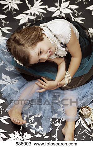 Portrait of a young girl playing dress up with costume jewelry View Large Photo Image Stock Image - Portrait of a young girl playing dress up with costume jewelry. Fotosearch
