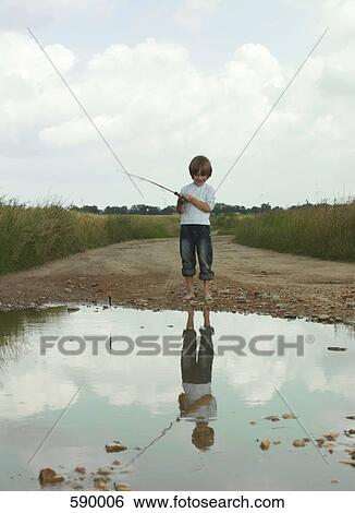 Stock Photograph - A boy fishing in a puddle. Fotosearch
